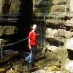 Caitlyn takes a shower in the waterfall